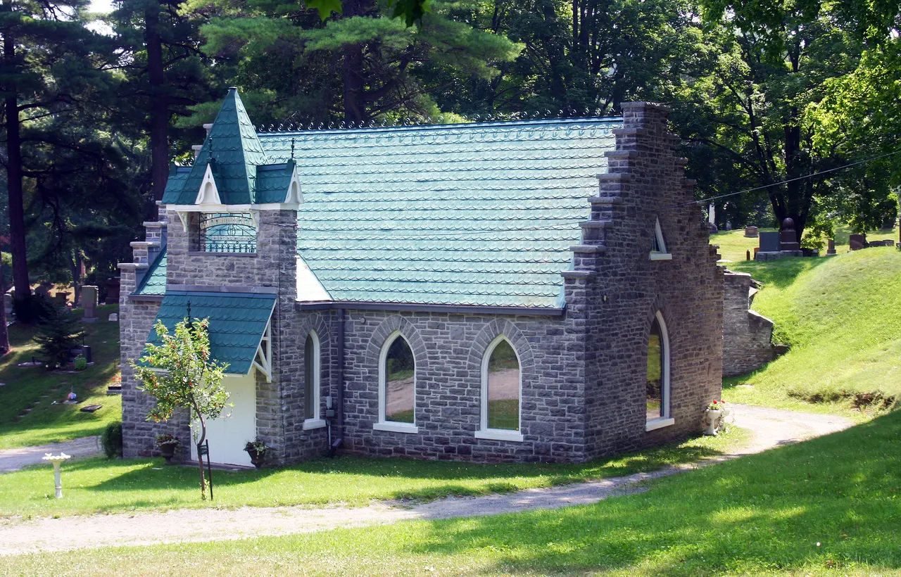 Stone chapel and tree-lined grounds at Glenwood Cemetery in Picton